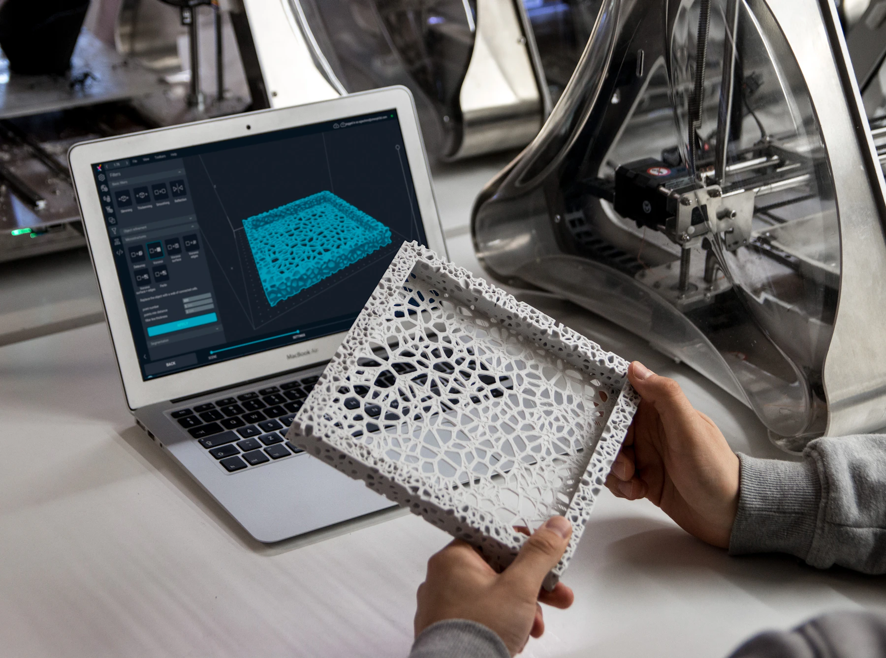 The same lattice frame physically printed and held beside its digital model